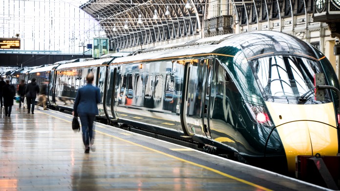 Train at a station with passengers on the platform