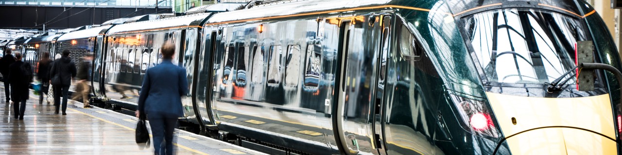 Train in a station with passengers on the platform